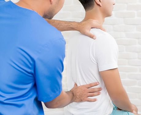 Therapist Treating Lower Back Pain — Opelika, AL — Meals Chiropractic Clinic Therapist Treating Lower Back Pain — Opelika, AL — Meals Chiropractic Clinic
