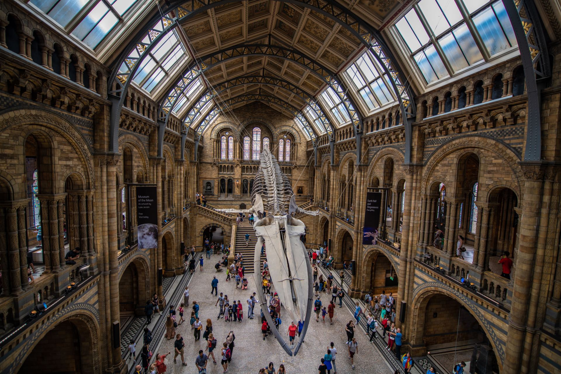 A large building with a lot of windows and people walking around it.