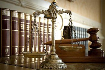 Scale of Justice with Gavel Behind - We Care in Corona, CA