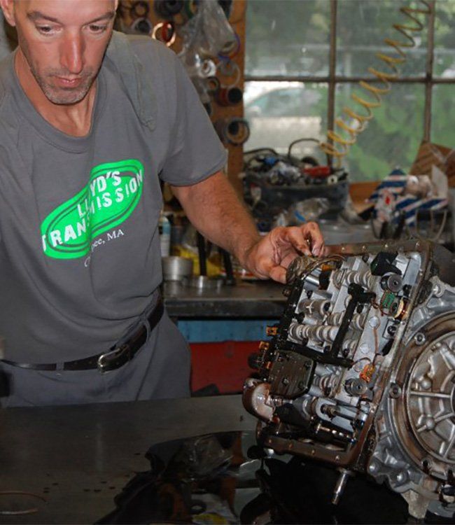 Man Replacing the Pan Gasket — Chicopee, MA — Lloyd's Transmission Inc. Man Replacing the Pan Gasket — Chicopee, MA — Lloyd's Transmission Inc.