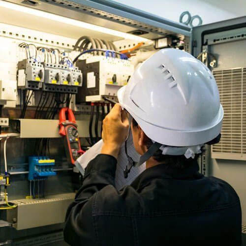Mechanical and electrical service offered by a man with  white safety helmet