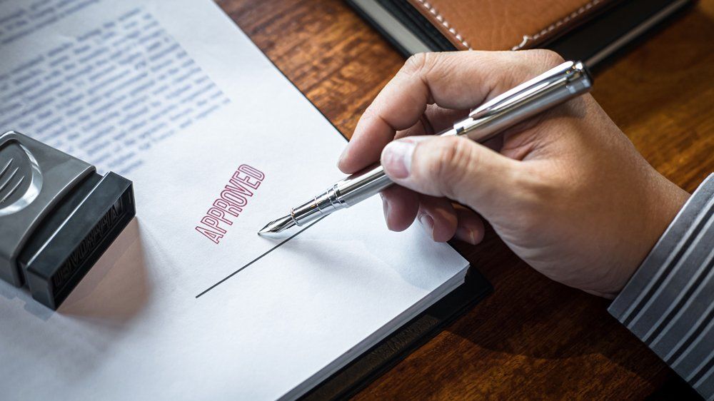 Close up Hands of Businessman Signing and Stamp on Paper Document — San Antonio, TX — Central Finance