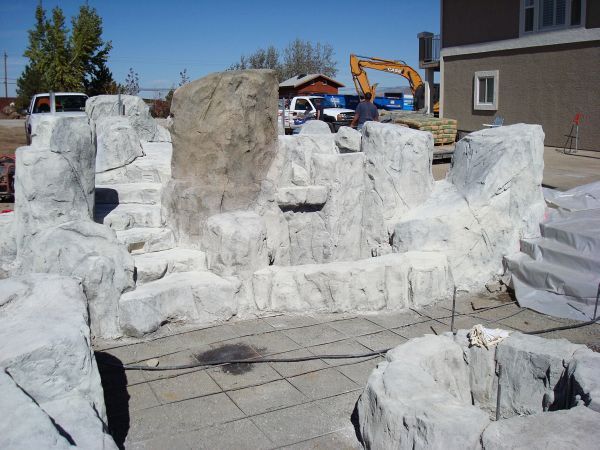 A large pile of rocks in front of a building