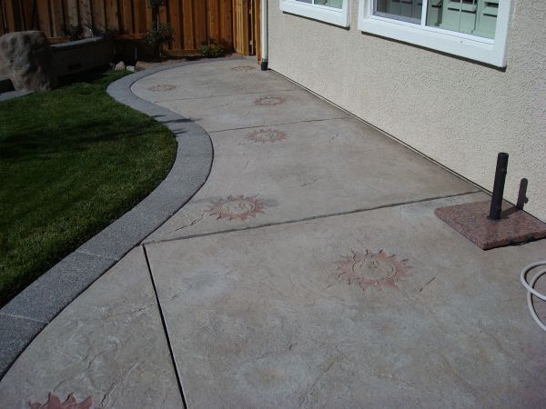 A concrete walkway with suns painted on it