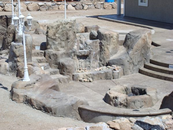 A rocky area with a fire pit and stairs