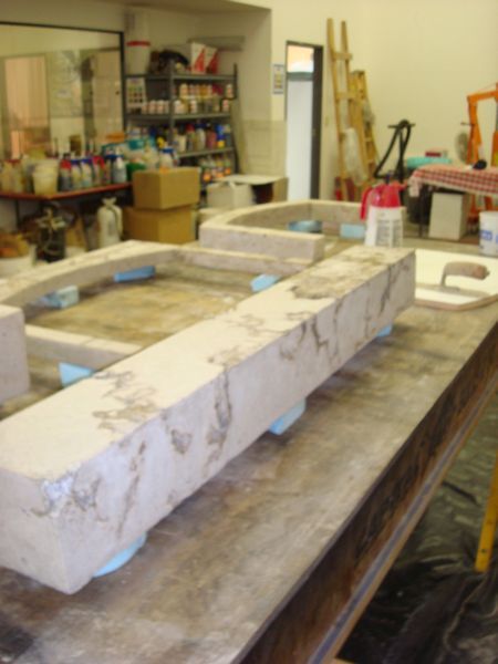 A large piece of concrete is sitting on a wooden table