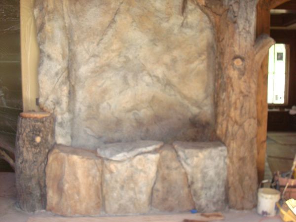 A stone wall with a tree stump carved into it