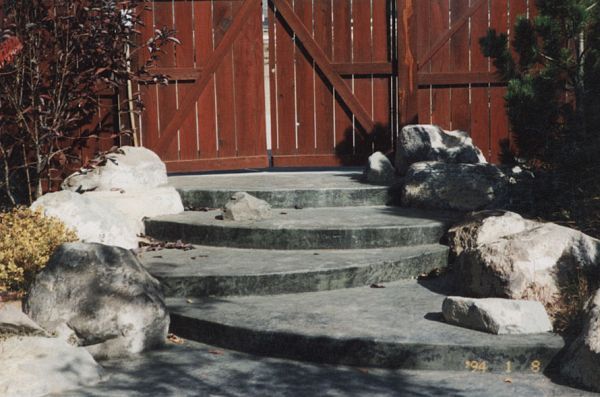 A set of stairs leading up to a wooden gate