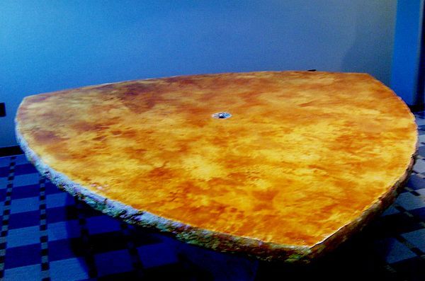 A large piece of wood is sitting on top of a table.