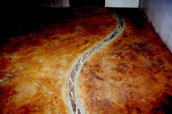 A close up of a concrete floor with a snake design on it.