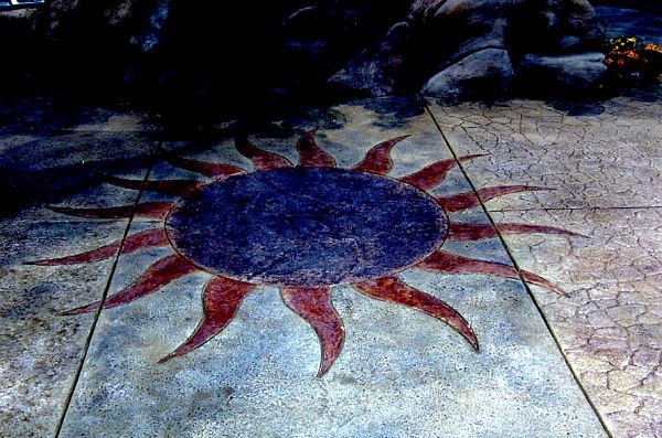 A painting of a sun on a concrete floor