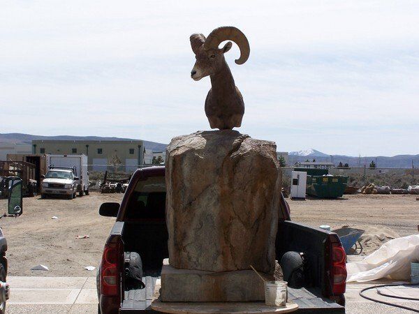 A concrete sculpture of a ram head.