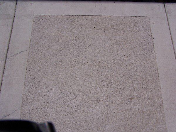 A piece of paper is laying on a tiled floor