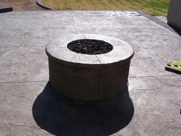 A concrete fire pit with a hole in the middle