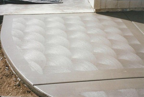 A concrete walkway with a geometric pattern on it