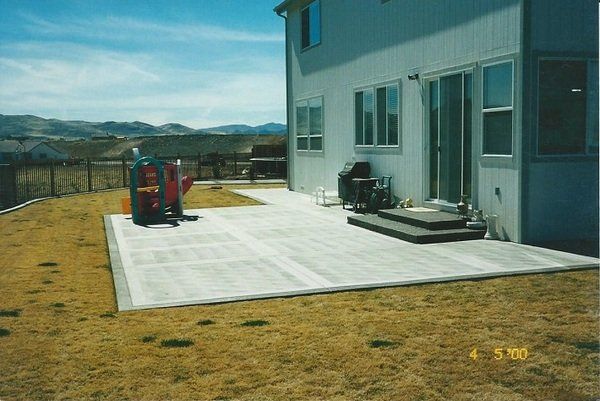 A house with a patio and a playground in front of it