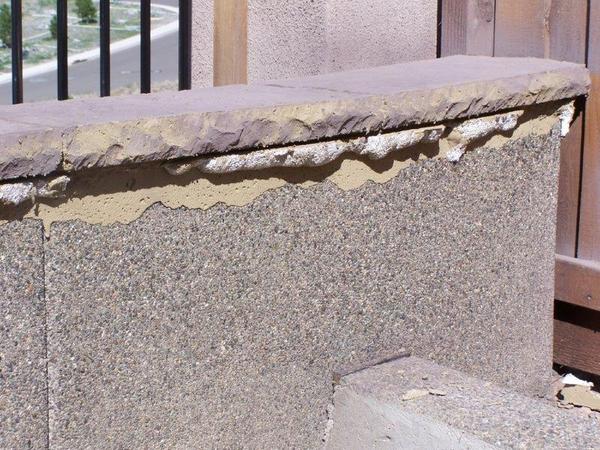 A concrete wall with a few pieces of cement on it
