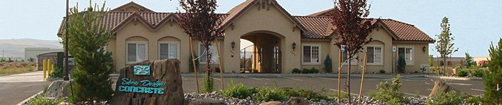 A large house with a sign in front of it.