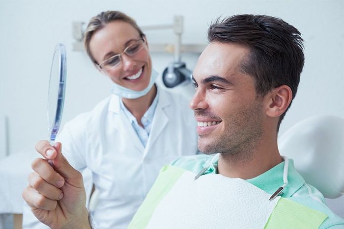 Patient Checking Results After Dental Procedure | Cincinnati Dental Care