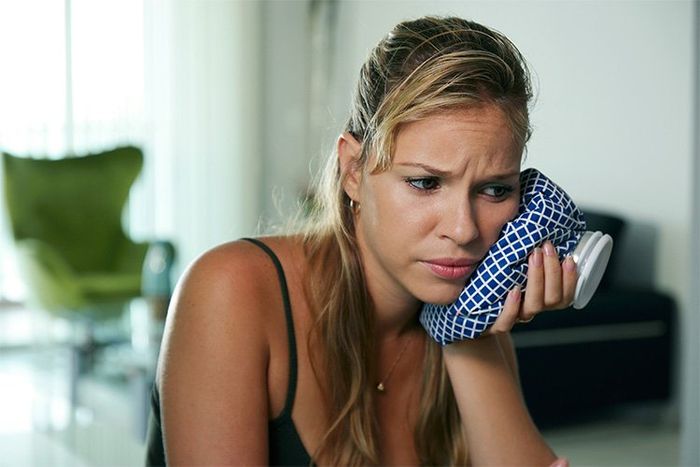 Woman Using Cold Compress for Toothache Pain | Cincinnati Dental Care