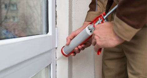Interior Sealing — Worker sealing the window in Carson CIty, NV Interior Sealing — Worker sealing the window in Carson CIty, NV