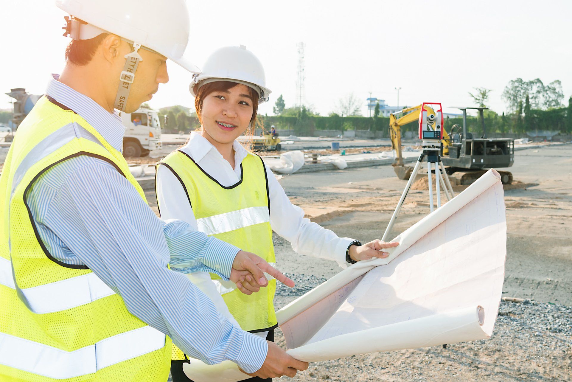 Site and Home Layout — Engineers Holding a Building Plan In Johnson City, TN Site and Home Layout — Engineers Holding a Building Plan In Johnson City, TN
