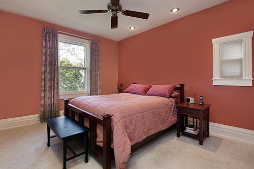 A ceiling fan in a master bedroom