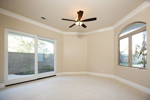 A ceiling fan in a master bedroom