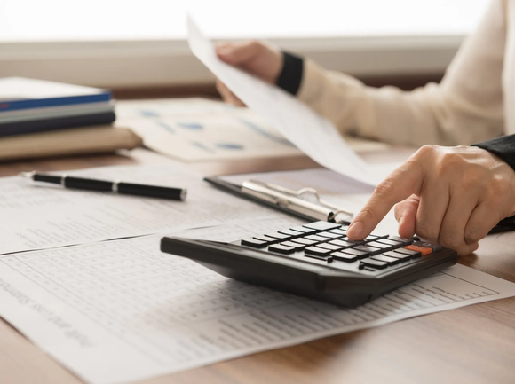 Woman Using Calculator — Connie Rodriguez Professional Services Inc — Downey, CA Woman Using Calculator — Connie Rodriguez Professional Services Inc — Downey, CA