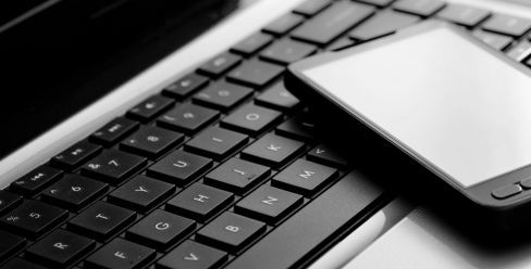 Cellphone and laptop at drafting services office in Common Moonbi