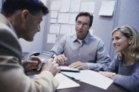 Couple consulting applying for building permit