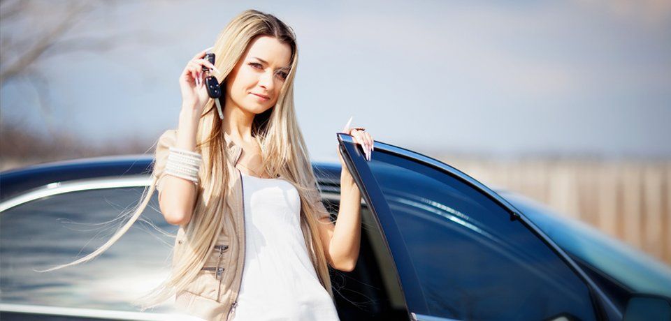 a lady holding the car key