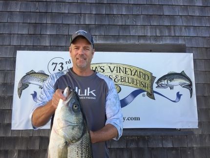 Man holding a fish caught with a Lew Dog Lure, Squid