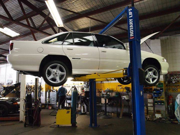 white car on lift