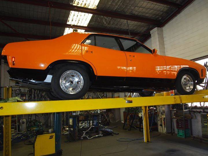 orange car on lift