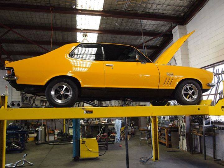 yellow car on lift