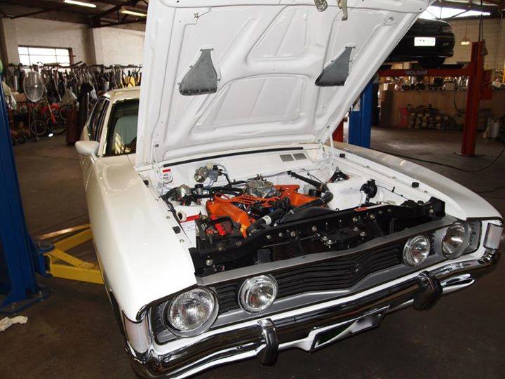 white car with hood open