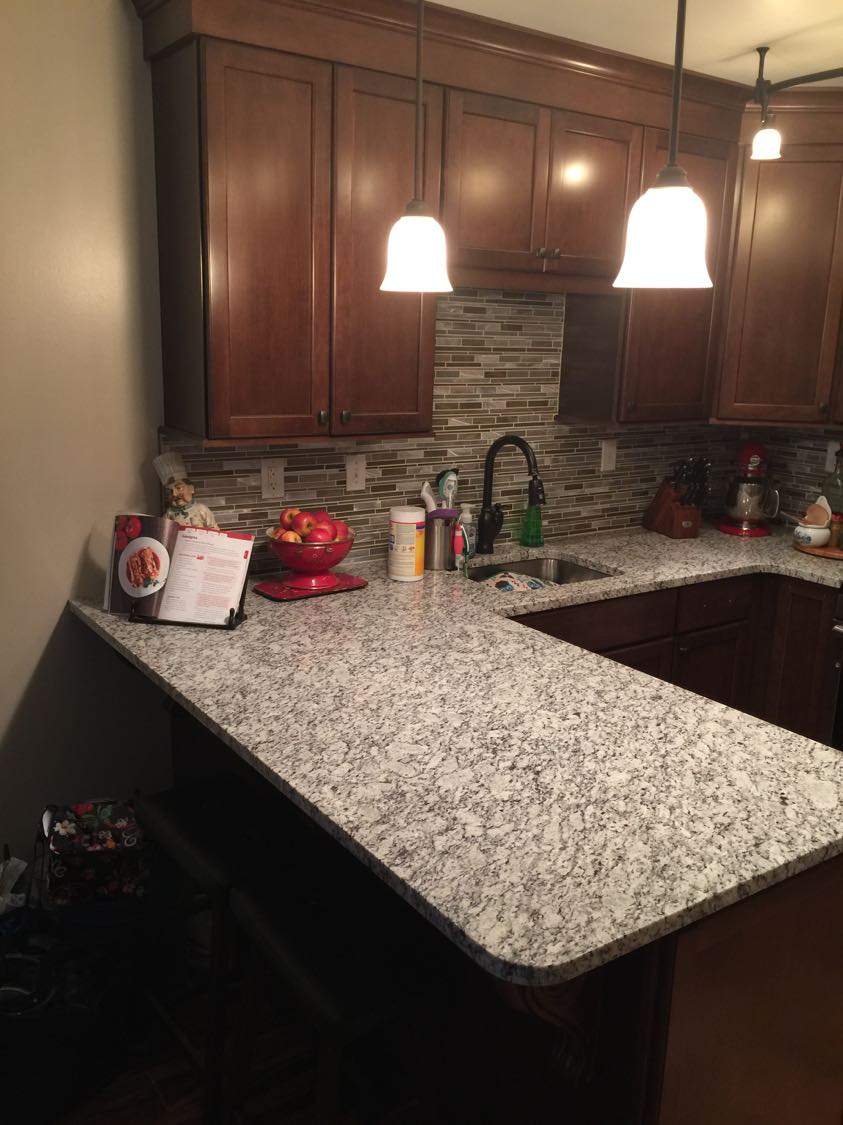 These countertop and backsplash colors pair well with the warm wood cabinets