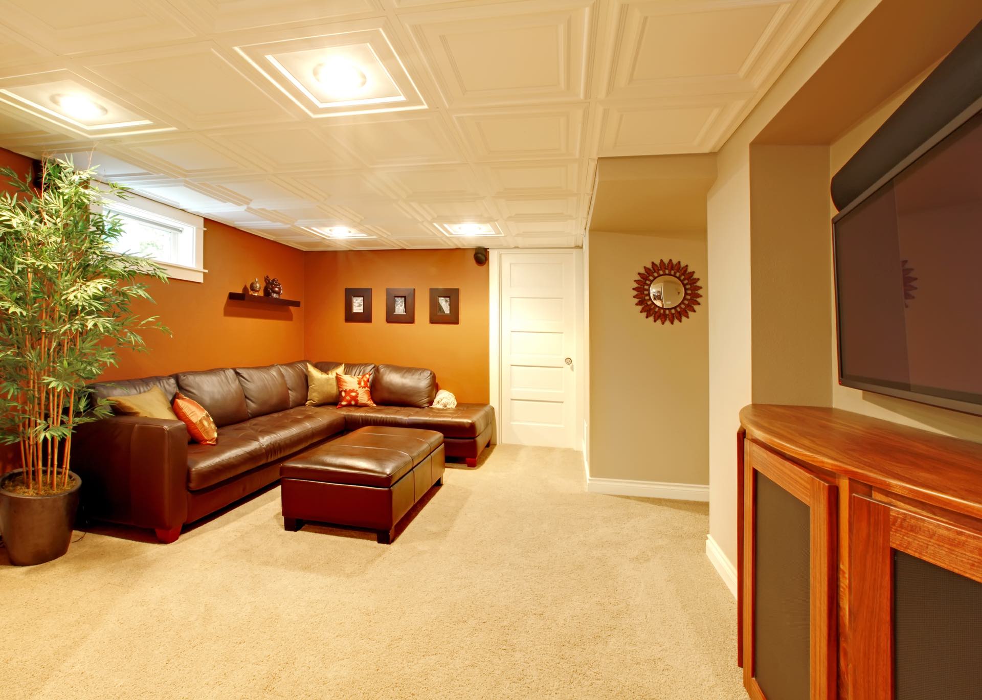 No need for a basement to be dark - remodel it to include bright lighting and warm colors to make it come alive!