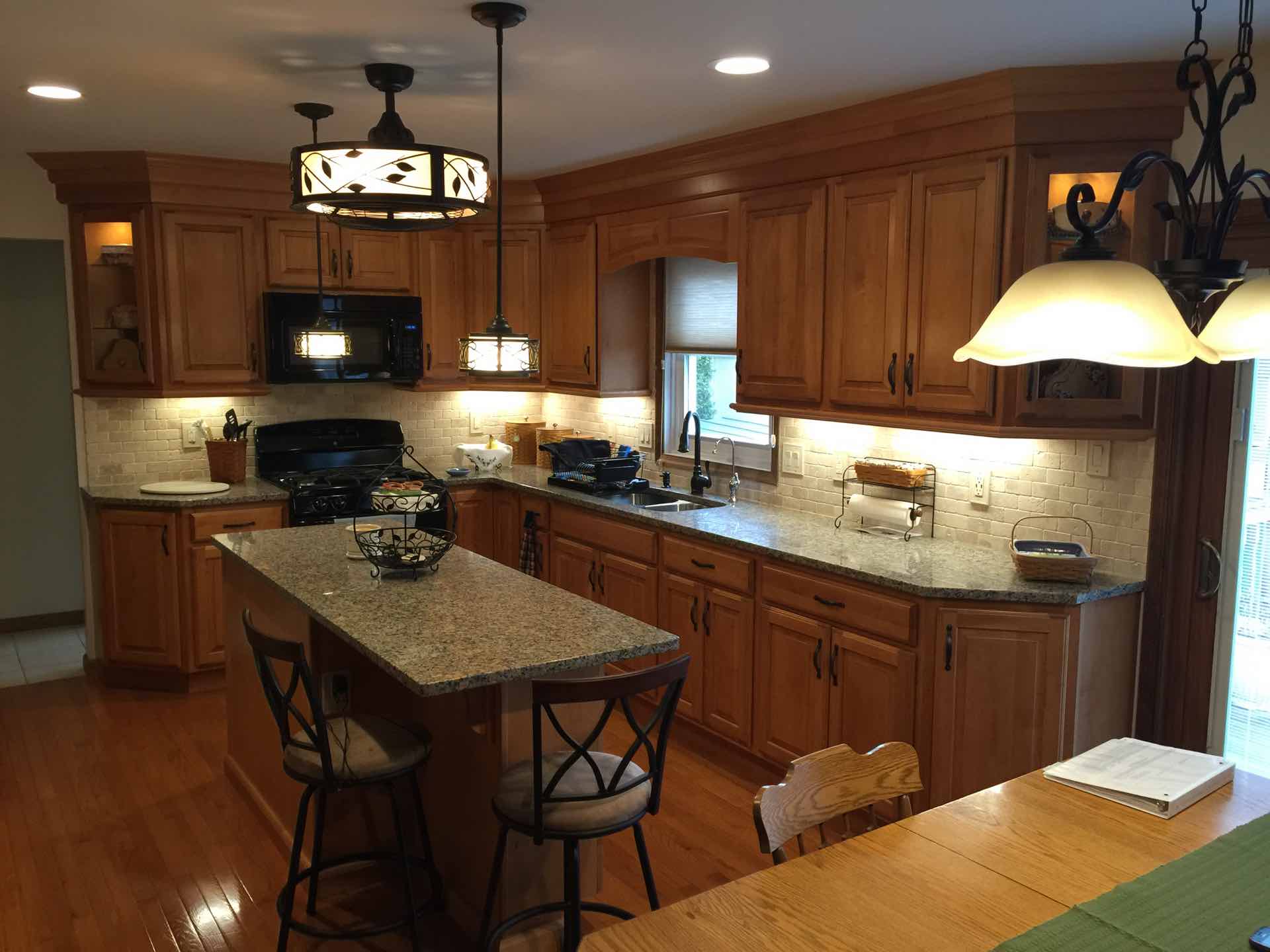 Amazing backsplash and countertop combo provides a great accent to these wood cabinets!