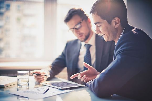 professionals working together on a tablet