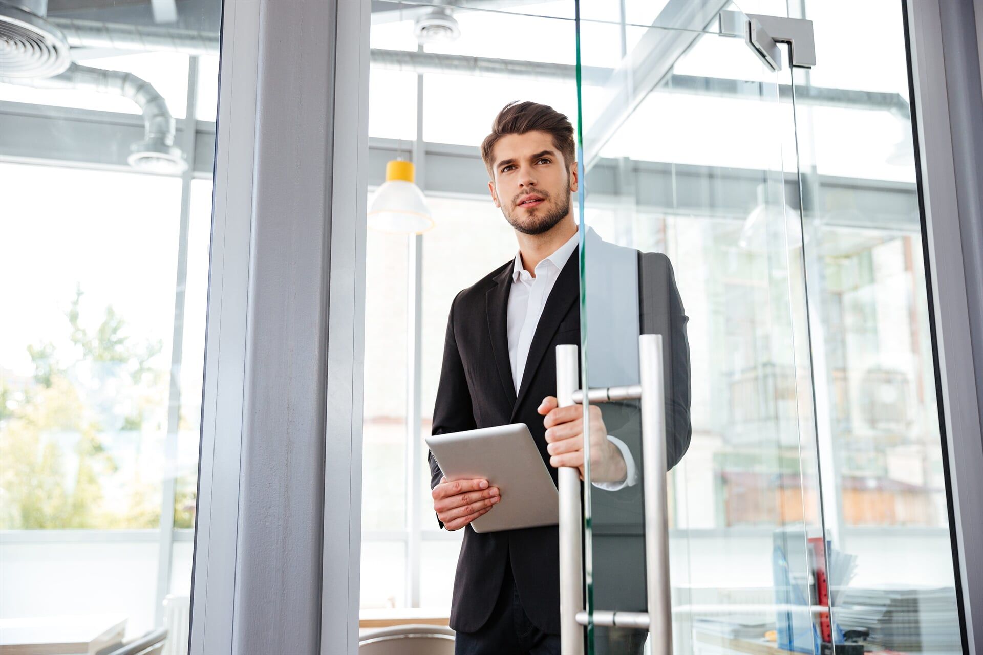 Man Holding A Tablet — North Coast Commercial Doors in Newcastle, NSW