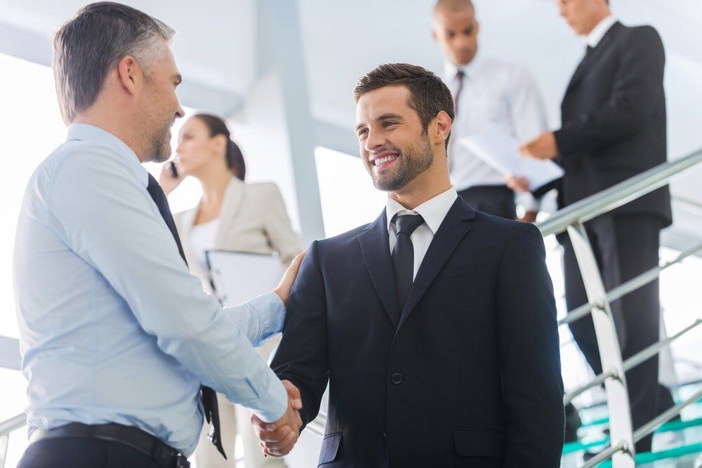 Business Man Shaking Hands — North Coast Commercial Doors in Newcastle, NSW