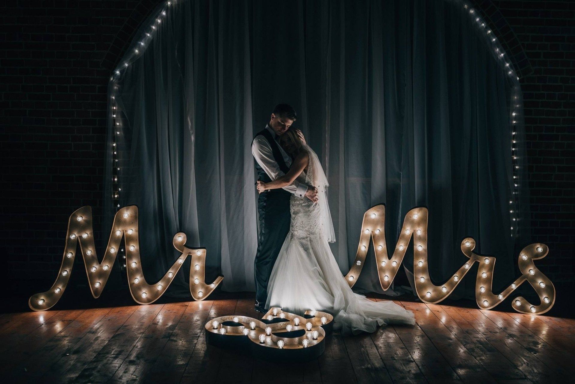 Newlyweds embrace in front of