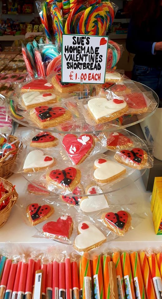 Candy store display with heart-shaped Valentine's shortbread cookies, lollipops, and candy canes.