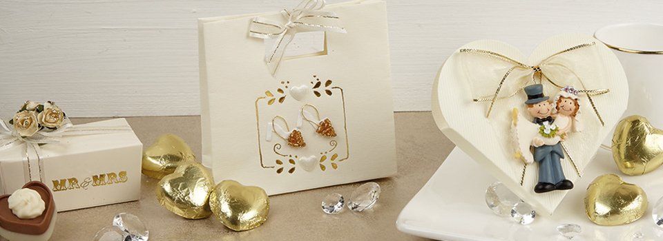 Wedding favors, including chocolates, gift bag, and heart-shaped decor.