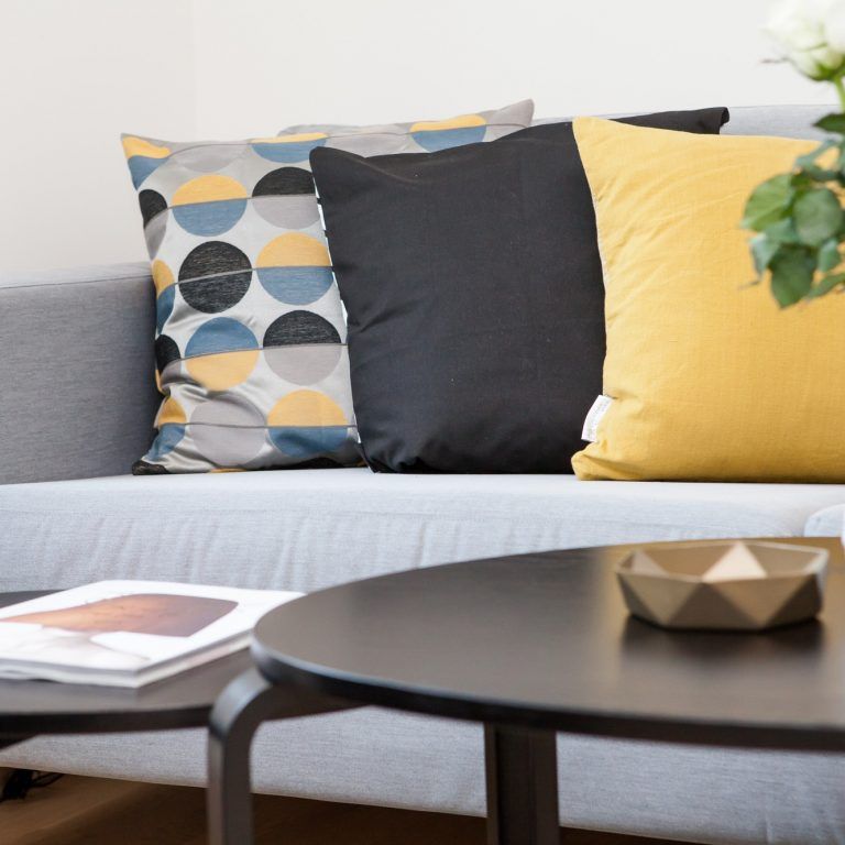 A couch with a bunch of pillows on it