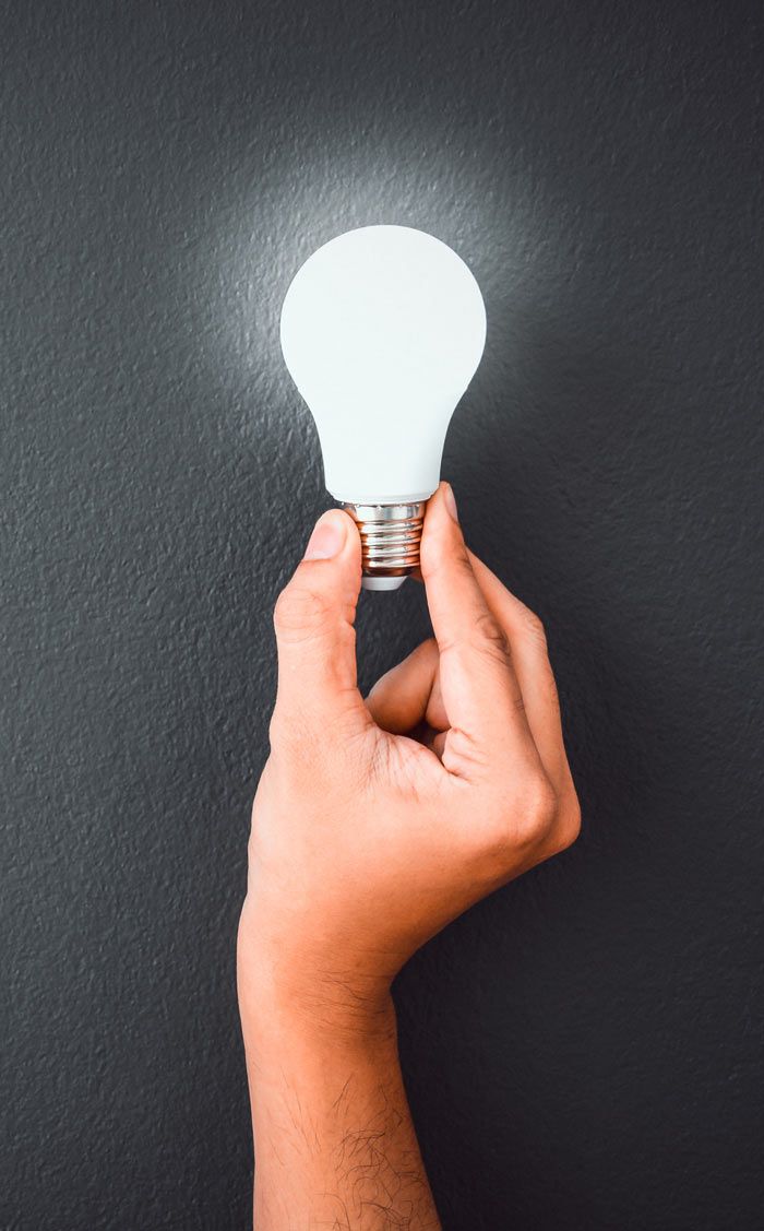 hand holding light bulb