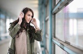 Woman listening to music on headphones