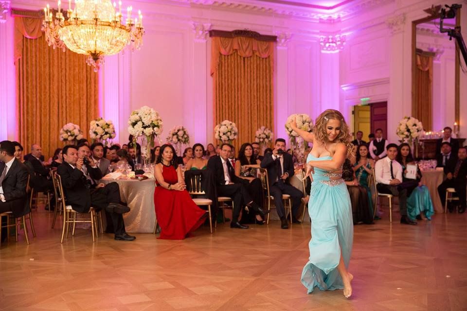 Woman dancing on dance floor in light blue dress